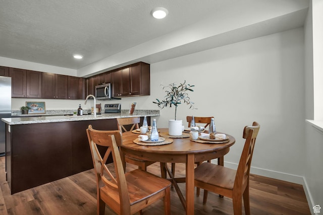 450 W Main St Unit 16, Santaquin, UT 84655 - dining area with dark wood finished floors, recessed lighting, baseboards, and a textured ceiling