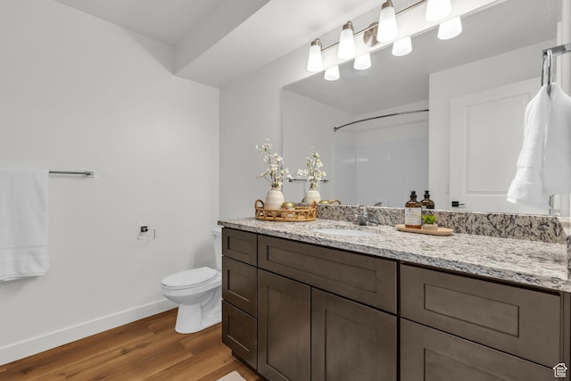 450 W Main St Unit 16, Santaquin, UT 84655 - bathroom featuring wood finished floors, toilet, baseboards, vanity, and a shower