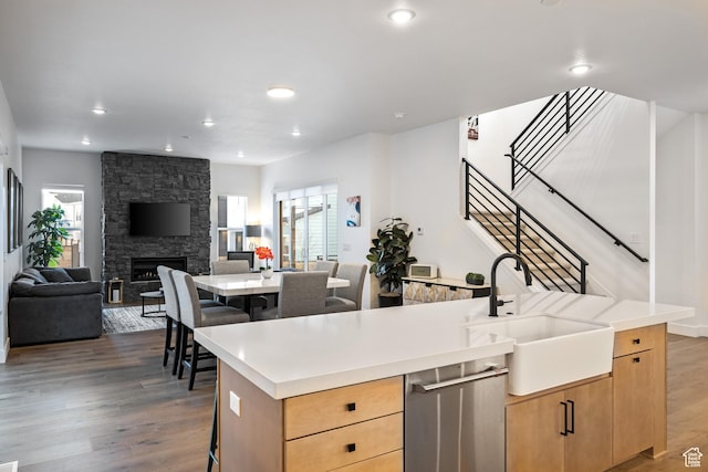 6592 Purple Poppy Ln Unit 117, Park City, UT 84098 - kitchen with a sink, dishwasher, light brown cabinets, wood finished floors, and open floor plan