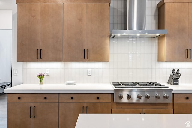 6592 Purple Poppy Ln Unit 117, Park City, UT 84098 - kitchen with wall chimney range hood, stainless steel gas stovetop, light countertops, and decorative backsplash