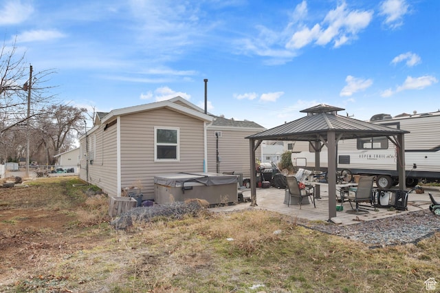 1632 W Whitlock Ave, West Valley City, UT 84119 - back of property featuring a gazebo, a patio area, and a hot tub