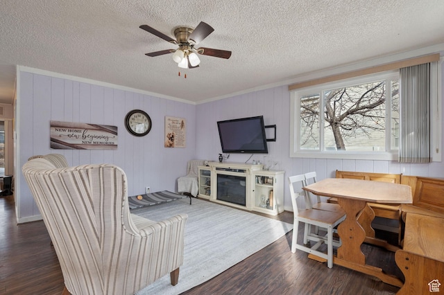 1632 W Whitlock Ave, West Valley City, UT 84119 - living area with wood finished floors, a textured ceiling, a ceiling fan, crown molding, and a glass covered fireplace