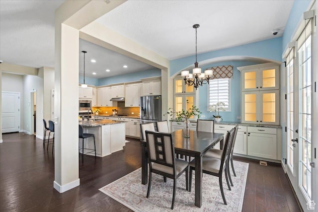 10451 S Abbott Way S, Jordan, UT 84009 - dining area featuring a chandelier, plenty of natural light, dark wood-style flooring, recessed lighting, and baseboards