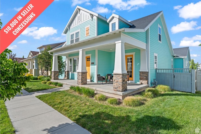 10451 S Abbott Way S, Jordan, UT 84009 - view of front of home with stone siding, covered porch, and a gate