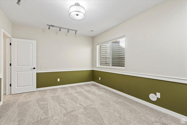 10451 S Abbott Way S, Jordan, UT 84009 - carpeted spare room with a textured ceiling, track lighting, and baseboards