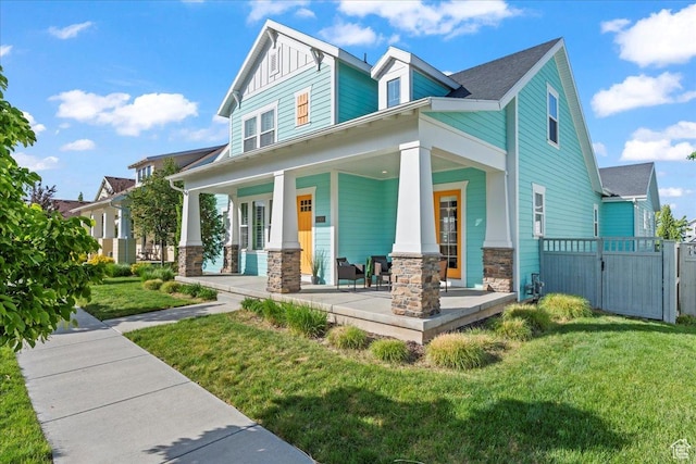 10451 S Abbott Way S, Jordan, UT 84009 - view of front of house featuring stone siding, a porch, and a gate