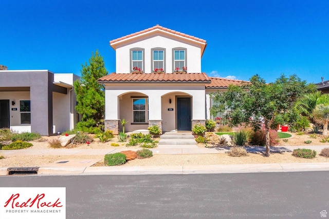 0, St. George, UT 84790 - view of front of property featuring stucco siding, a tiled roof, a porch, and stone siding
