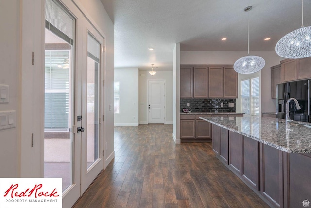 0, St. George, UT 84790 - kitchen featuring black refrigerator with ice dispenser, healthy amount of natural light, tasteful backsplash, baseboards, and recessed lighting
