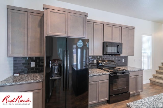0, St. George, UT 84790 - kitchen with black appliances, tasteful backsplash, light stone countertops, and wood finished floors