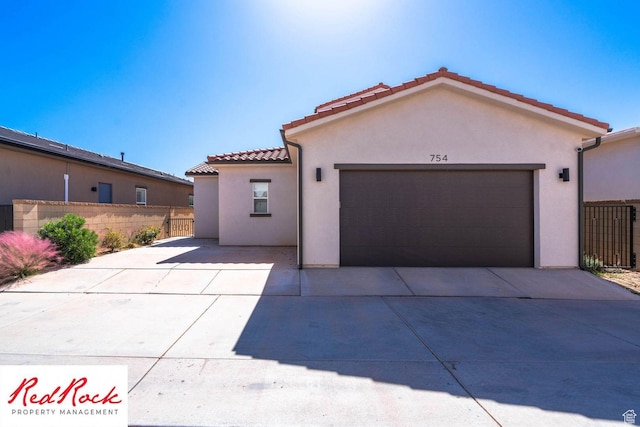 0, St. George, UT 84790 - mediterranean / spanish house featuring stucco siding, a tile roof, concrete driveway, and a garage