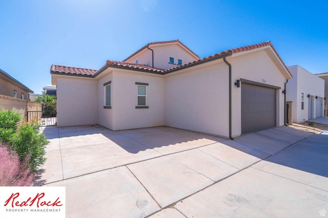 0, St. George, UT 84790 - mediterranean / spanish home featuring an attached garage, driveway, stucco siding, and a tile roof