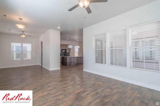 0, St. George, UT 84790 - unfurnished living room with a ceiling fan, dark wood-type flooring, baseboards, recessed lighting, and a sink