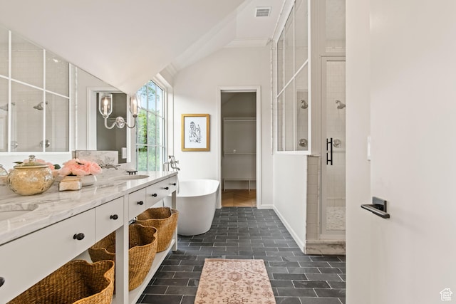 520 N H St E, Salt Lake City, UT 84103 - full bathroom featuring a shower stall, a freestanding bath, double vanity, vaulted ceiling, and baseboards