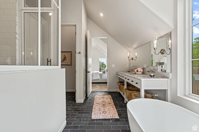 520 N H St E, Salt Lake City, UT 84103 - full bathroom with ensuite bath, a freestanding bath, lofted ceiling, vanity, and tile patterned flooring