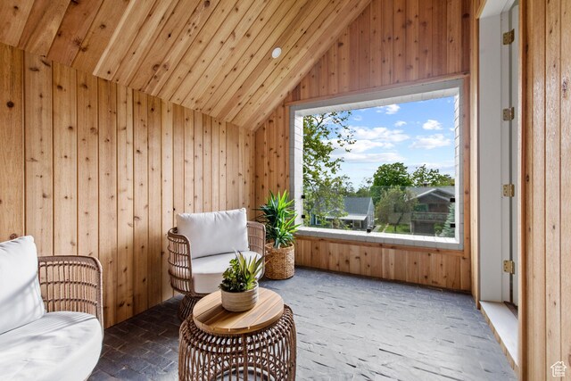 520 N H St E, Salt Lake City, UT 84103 - living area with vaulted ceiling, wooden walls, wooden ceiling, and brick patterned floors