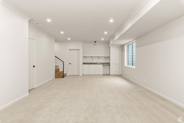 520 N H St E, Salt Lake City, UT 84103 - unfurnished living room featuring crown molding, stairs, recessed lighting, baseboards, and light colored carpet