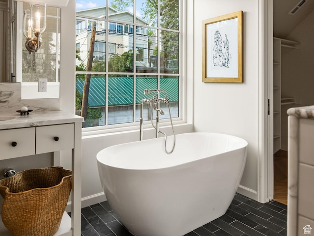 520 N H St E, Salt Lake City, UT 84103 - full bath featuring a freestanding tub, baseboards, vanity, and tile patterned floors