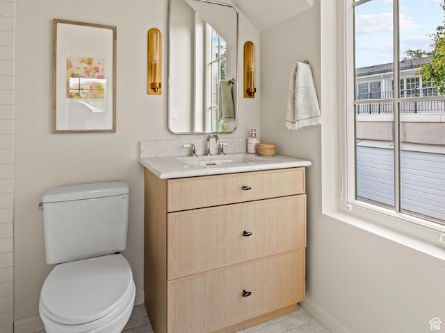 520 N H St E, Salt Lake City, UT 84103 - bathroom with healthy amount of natural light, toilet, baseboards, and vanity