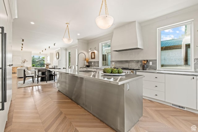 520 N H St E, Salt Lake City, UT 84103 - kitchen with premium range hood, modern cabinets, crown molding, white cabinetry, and a sink
