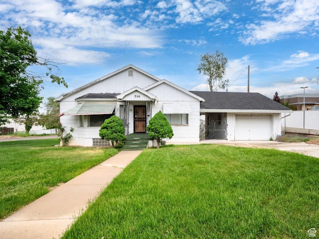 356 39th St, South Ogden, UT 84405 - view of front of property featuring a front lawn, driveway, an attached garage, and a shingled roof
