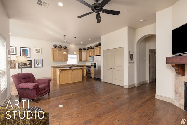 280 S Luce Del Sol Dr Unit 316, St George, UT 84770 - living area with arched walkways, ceiling fan, dark wood-type flooring, a fireplace, and recessed lighting