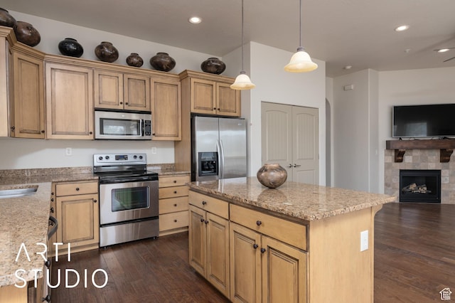 280 S Luce Del Sol Dr Unit 316, St George, UT 84770 - kitchen featuring appliances with stainless steel finishes, open floor plan, dark wood-type flooring, light stone countertops, and decorative light fixtures