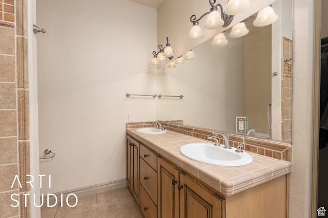 280 S Luce Del Sol Dr Unit 316, St George, UT 84770 - full bath featuring tile patterned floors, double vanity, baseboards, and a chandelier