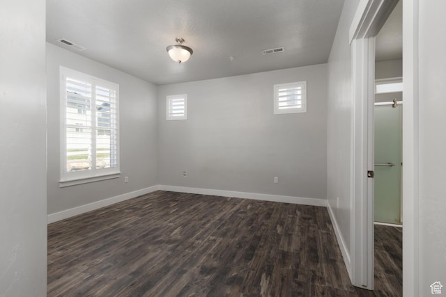13092 S Tortola Dr Unit 101, Herriman, UT 84096 - spare room featuring healthy amount of natural light and dark wood-type flooring
