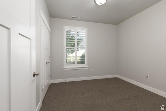 13092 S Tortola Dr Unit 101, Herriman, UT 84096 - unfurnished bedroom with dark colored carpet and a closet