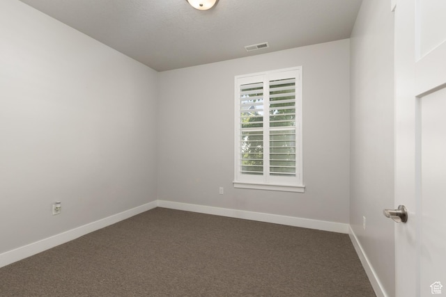 13092 S Tortola Dr Unit 101, Herriman, UT 84096 - unfurnished room featuring dark carpet and a textured ceiling