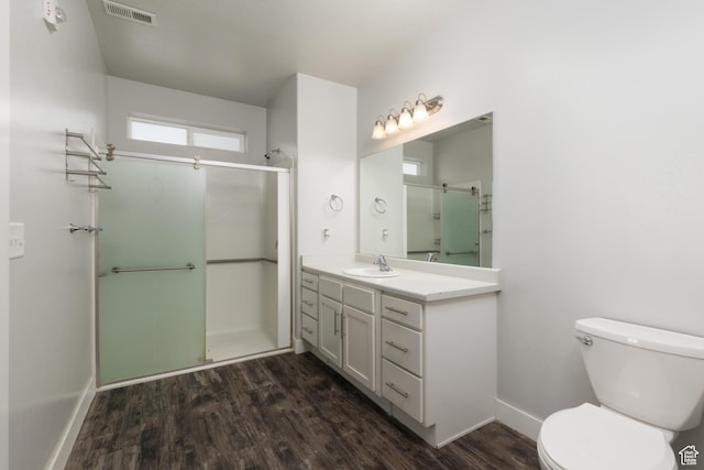 13092 S Tortola Dr Unit 101, Herriman, UT 84096 - bathroom featuring a stall shower, wood finished floors, and vanity