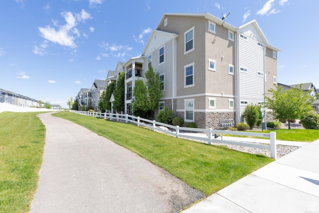 13092 S Tortola Dr Unit 101, Herriman, UT 84096 - view of building exterior featuring a residential view