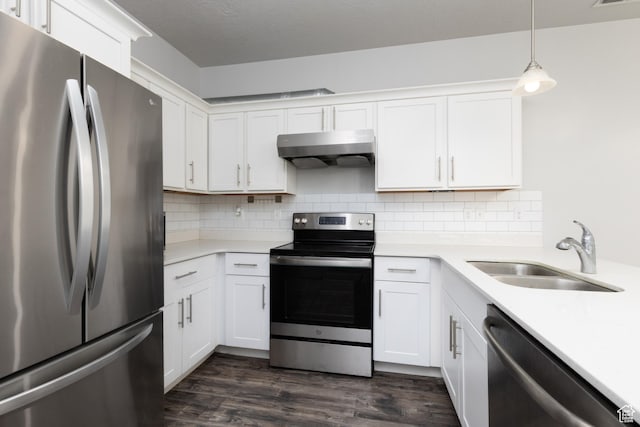 13092 S Tortola Dr Unit 101, Herriman, UT 84096 - kitchen featuring stainless steel appliances, under cabinet range hood, light countertops, and dark wood-style flooring