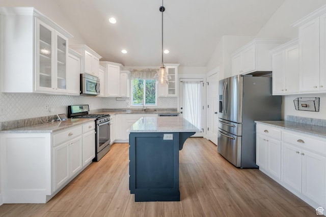 488 E Acord Way, Heber City, UT 84032 - kitchen featuring stainless steel appliances, a sink, white cabinetry, decorative backsplash, and lofted ceiling