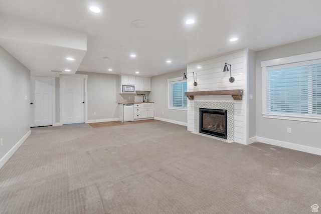 488 E Acord Way, Heber City, UT 84032 - unfurnished living room featuring light carpet, a fireplace, baseboards, and recessed lighting
