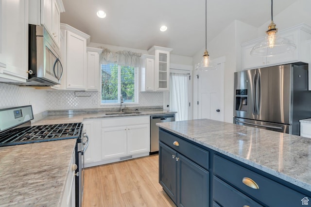 488 E Acord Way, Heber City, UT 84032 - kitchen featuring appliances with stainless steel finishes, a sink, white cabinets, decorative backsplash, and light wood-style floors