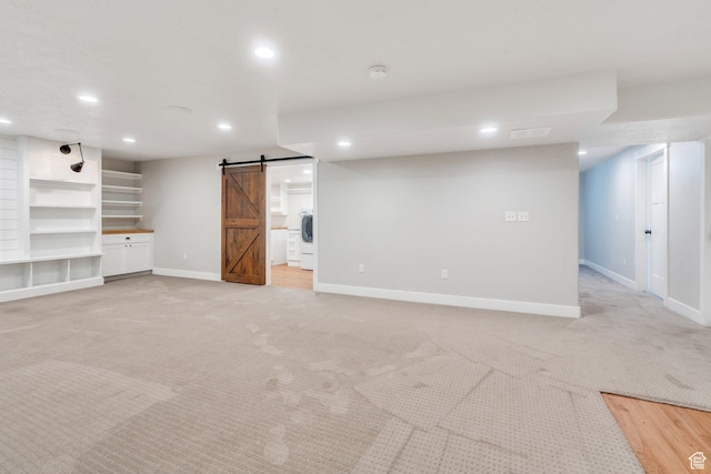 488 E Acord Way, Heber City, UT 84032 - finished below grade area featuring a barn door, recessed lighting, baseboards, light carpet, and washer / dryer