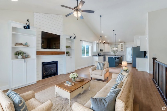 488 E Acord Way, Heber City, UT 84032 - living room with light wood-style floors, ceiling fan, high vaulted ceiling, baseboards, and a large fireplace