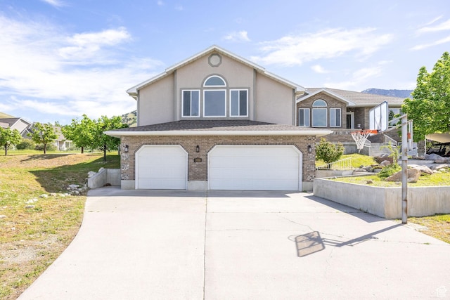 304 N 1000 E, Hyde Park, UT 84318 - view of front of property featuring a garage, driveway, stucco siding, and brick siding