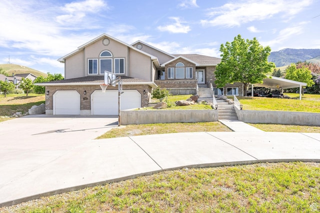304 N 1000 E, Hyde Park, UT 84318 - view of front of house with an attached garage, concrete driveway, stucco siding, and a front lawn