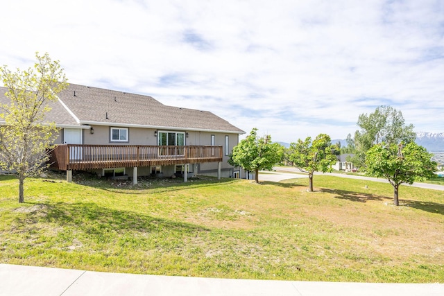 304 N 1000 E, Hyde Park, UT 84318 - rear view of property featuring a wooden deck, a lawn, and a shingled roof