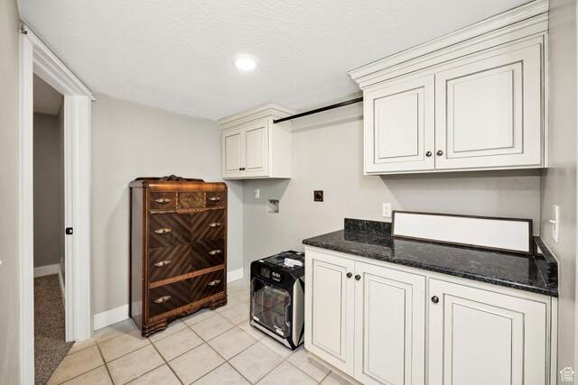 304 N 1000 E, Hyde Park, UT 84318 - kitchen with baseboards, dark stone counters, and light tile patterned flooring