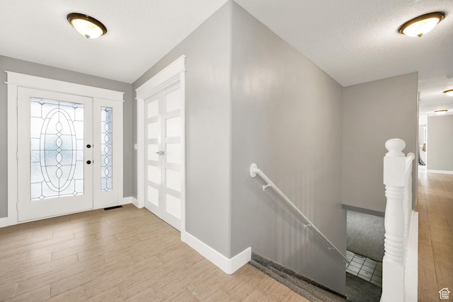 304 N 1000 E, Hyde Park, UT 84318 - entryway featuring wood finished floors, baseboards, and a textured ceiling