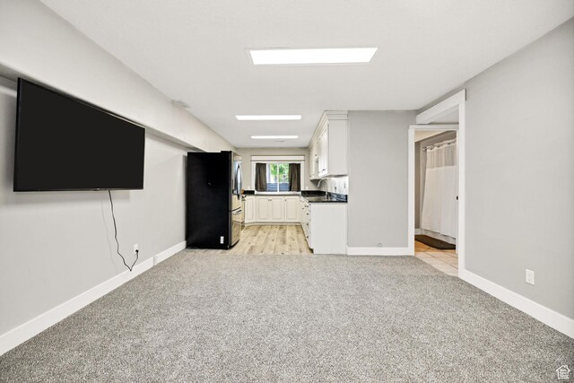 304 N 1000 E, Hyde Park, UT 84318 - unfurnished living room with light carpet and baseboards