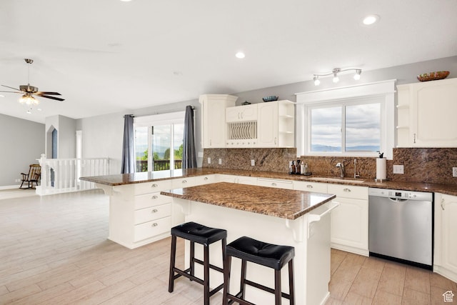 304 N 1000 E, Hyde Park, UT 84318 - kitchen featuring dishwasher, open shelves, a peninsula, a kitchen breakfast bar, and decorative backsplash