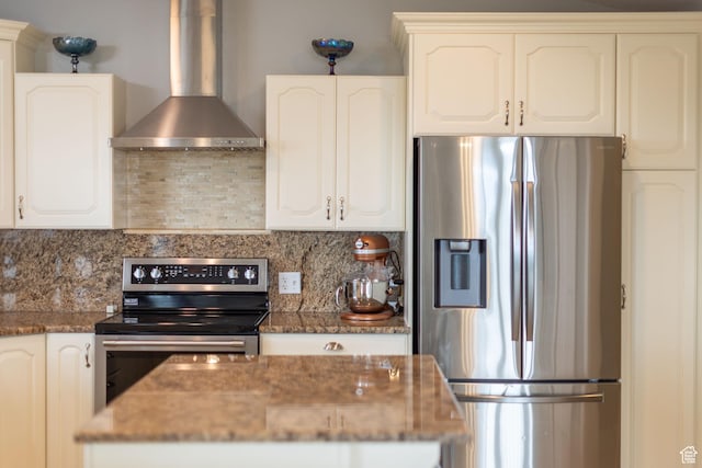 304 N 1000 E, Hyde Park, UT 84318 - kitchen with appliances with stainless steel finishes, wall chimney range hood, tasteful backsplash, and dark stone counters