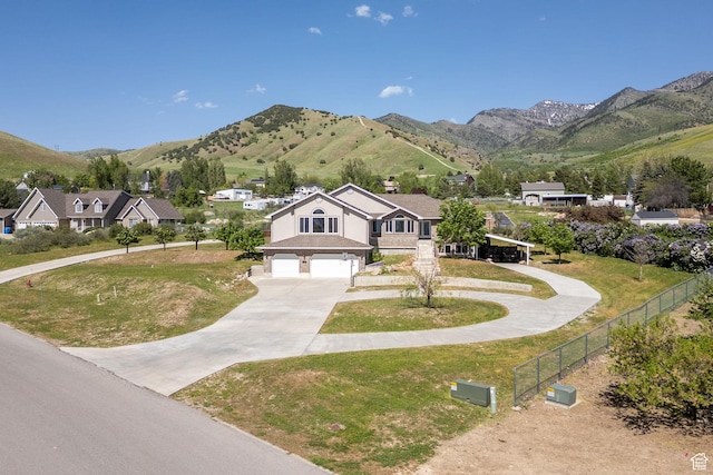 304 N 1000 E, Hyde Park, UT 84318 - view of front of property with concrete driveway, a garage, and a mountain view