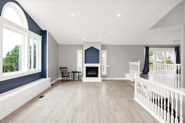 304 N 1000 E, Hyde Park, UT 84318 - unfurnished living room featuring wood finished floors, a glass covered fireplace, baseboards, and recessed lighting