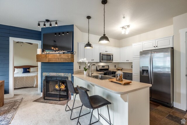 8430 Gambel Dr Unit Q23, Park City, UT 84098 - kitchen with appliances with stainless steel finishes, a peninsula, light countertops, a breakfast bar area, and white cabinetry