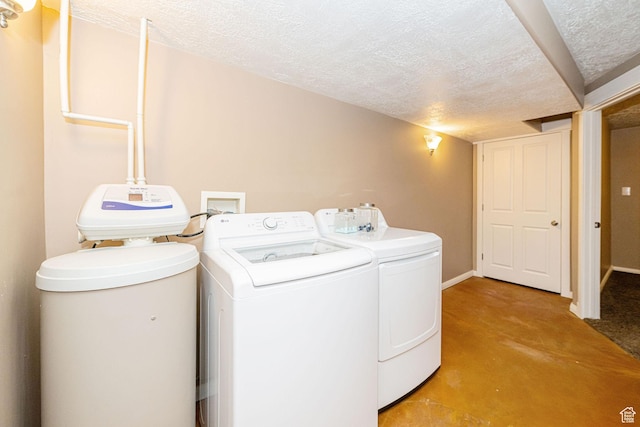 6045 S 2000 E, South Ogden, UT 84403 - laundry area with a textured ceiling, washer and clothes dryer, light colored carpet, and baseboards